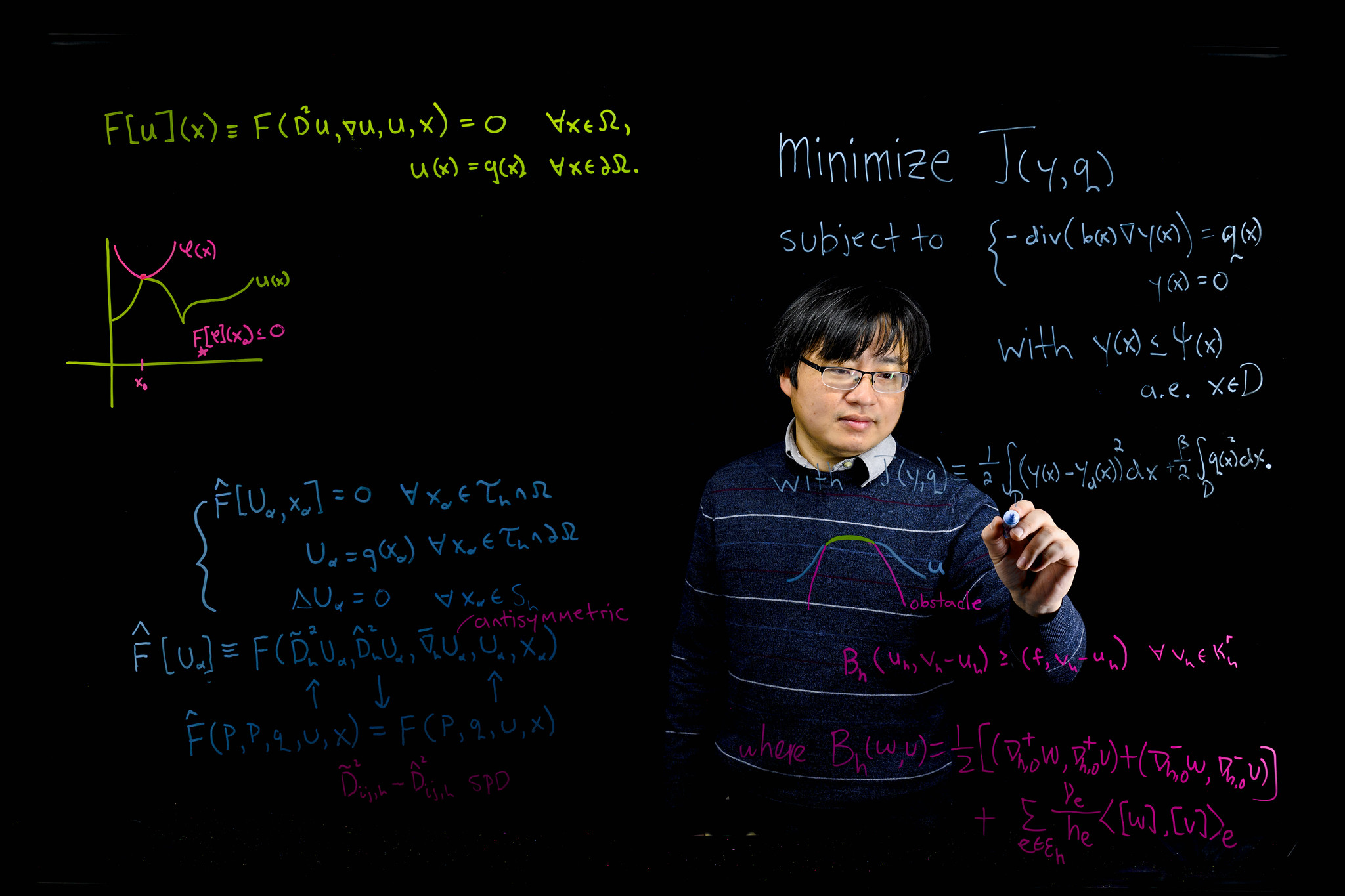 UNCG Math & Statistics professor writing on a board